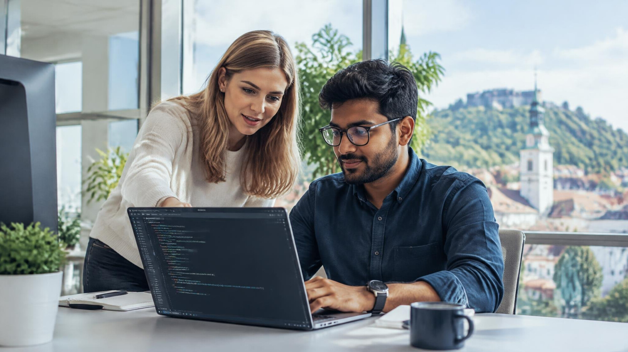 Team of professionals collaborating on code in a modern office
